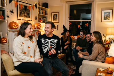 Halloween outfit ideas with themed jumpers at a house party